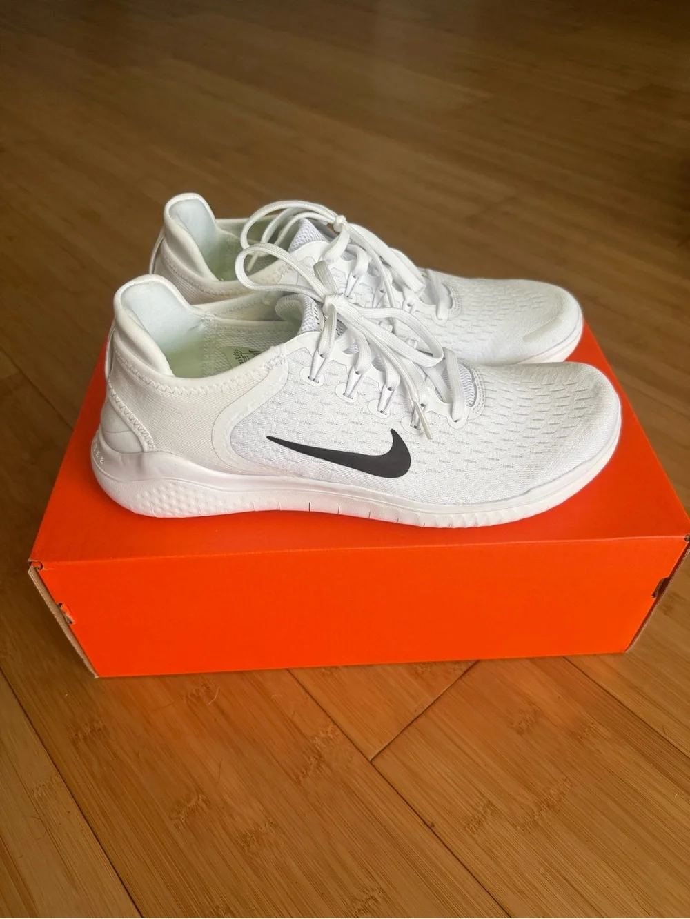 Nike Kids White Sneakers with Black Swoosh